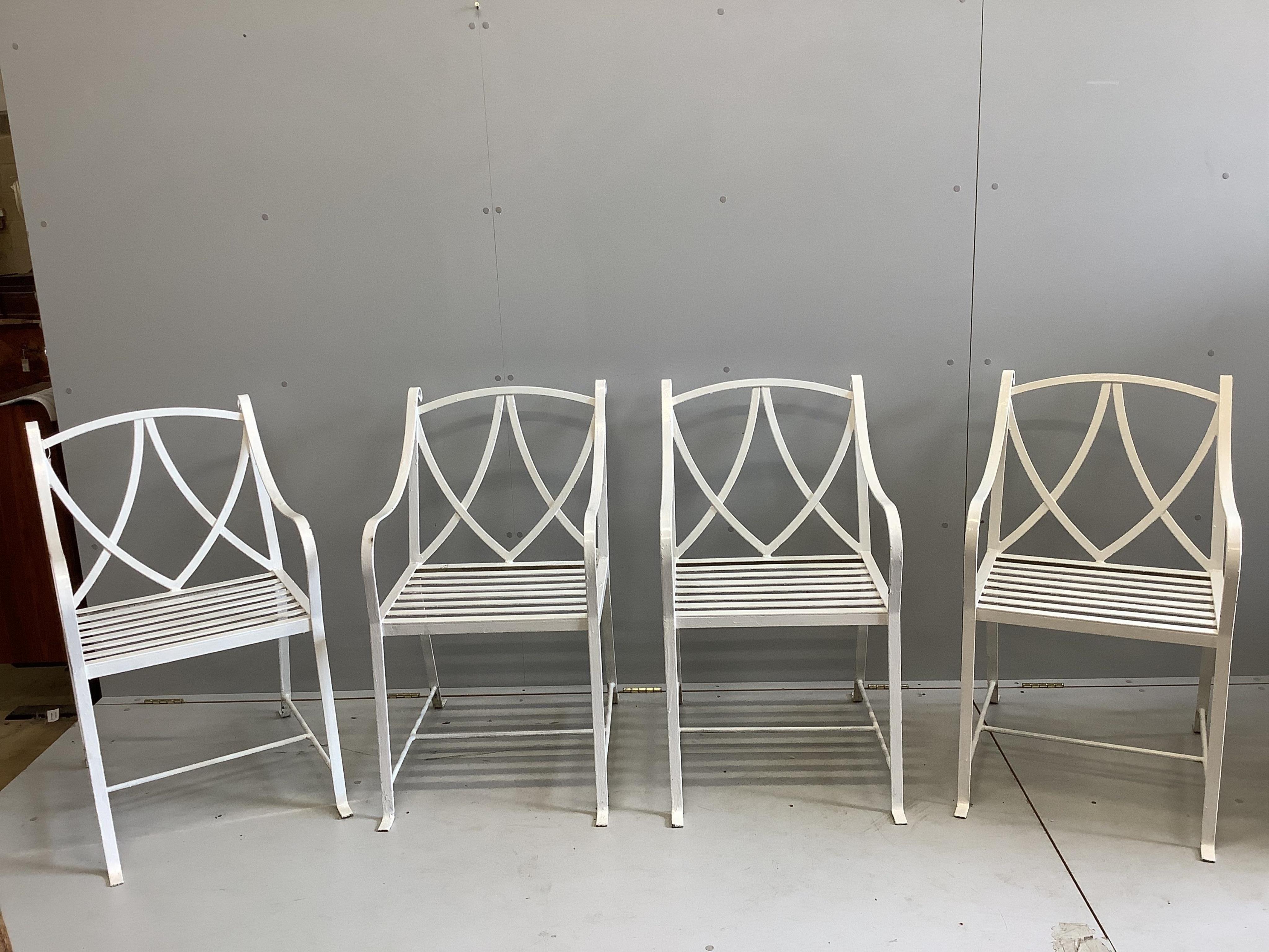 A set of four painted wrought iron strapwork garden chairs, width 51cm, depth 64cm, height 90cm. Condition - good